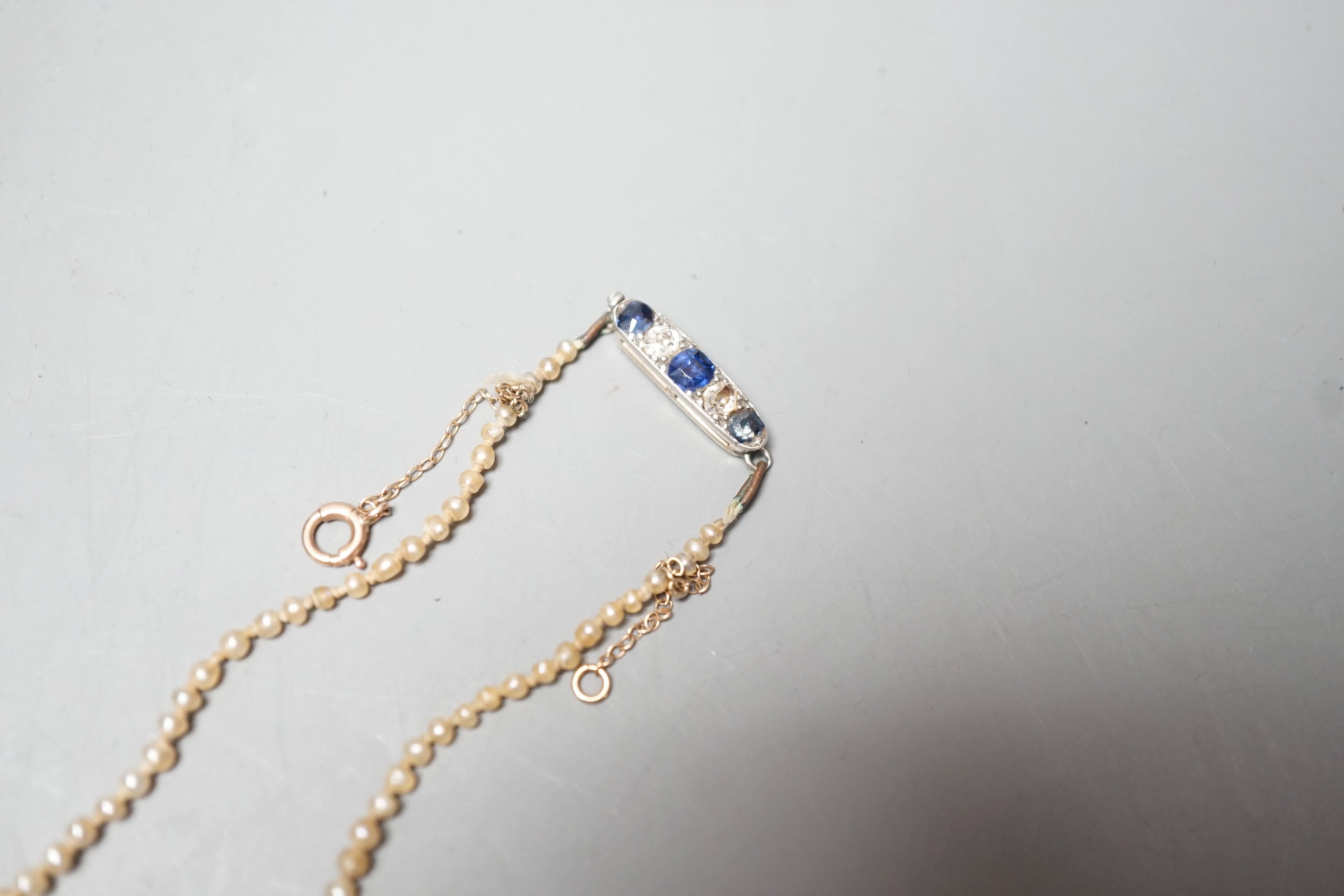 A single strand graduated natural saltwater pearl necklace, with sapphire and diamond set clasp, 44cm, gross weight 7 grams, with accompanying GCS report dated 23/11/2022.